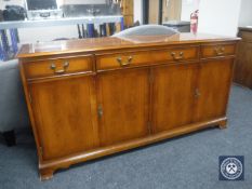 An inlaid yew wood sideboard