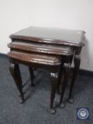 A nest of three mahogany tables