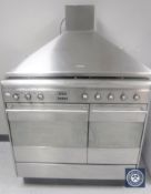 A Smeg stainless steel five burner gas range cooker together with an extraction hood,
