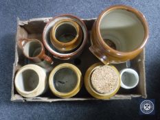 A box containing seven stoneware kitchen jars together with a stone ware jug