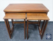 A teak foldover top table fitted two beneath
