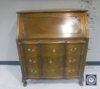 An oak bureau fitted three drawers