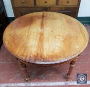 A mahogany circular dining table