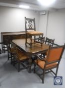 An American Berkey & Gay carved oak dining room suite comprising extending dining table,