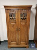 A carved oak double door bookcase cabinet, width 92 cm.