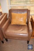 A mid 20th century continental brown leather armchair