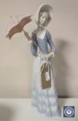 A Lladro figure of a lady holding a parasol,