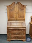 A nineteenth century continental oak bureau bookcase, width 107 cm.