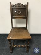A Victorian carved oak hall chair