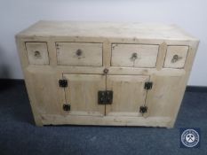A pine sideboard fitted four drawers and cupboards beneath