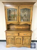 A glazed oak kitchen dresser