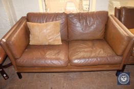 A mid 20th century continental brown leather two seater settee