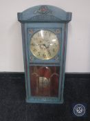 An early 20th century painted cased wall clock