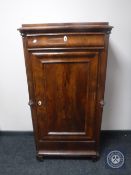 A 19th century continental mahogany sentry door cabinet fitted a drawer