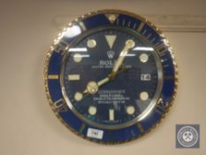A circular battery operated Rolex Submariner advertising clock