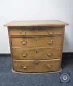 A continental oak four drawer chest with brass drop handles