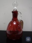 A Victorian cranberry glass jug