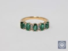A 14ct yellow gold emerald and diamond ring featuring 5 oval cut natural diamonds 1.