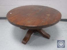 A circular oak pedestal coffee table