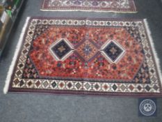 A rug of Afshar design, with a column of three hooked medallions,
