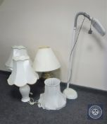 A brass table lamp with shade together with two other table lamps with shades and angle poised