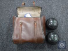 A leather case containing a set of four Championship Pynes lawn bowls