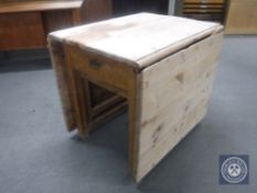 A 19th century pine drop leaf kitchen table fitted a drawer