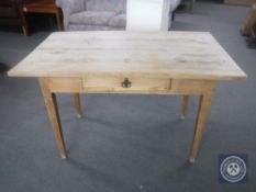 An early 20th century pine kitchen table fitted a drawer
