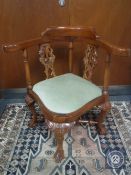 A mahogany corner armchair on claw and ball feet