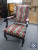 An early 20th century painted scroll arm armchair upholstered in a striped fabric