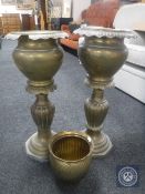 Two brass jardiniere stands together with a brass planter