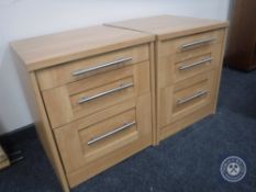 A pair of pine effect two drawer bedside chests with slides