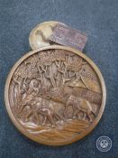 A large carved circular wall plaque together with a puzzle box and contents,