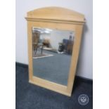 An early 20th century pine framed bevelled mirror