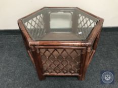 A glass topped wicker coffee table