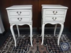 A pair of cream and gilt two drawer bedside stands