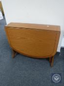 A teak drop leaf table