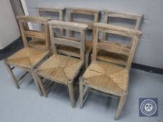 A set of six rush seated church chairs