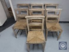 A set of seven rush seated church chairs