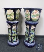 A pair of glazed pottery jardiniere on stands