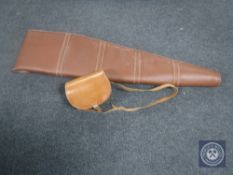 A brown leather shotgun carry case together with a leather cartridge bag