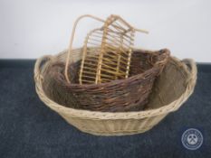 Two wicker log baskets and a magazine rack