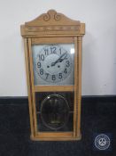 A continental oak cased eight day wall clock