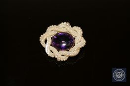 A Victorian amethyst and pearl brooch in gold mount