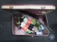 A mid 20th century luggage case containing brass hand bell, cufflinks, Casio hand held TV,