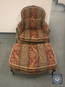 A reproduction gentleman's armchair with matching footstool.