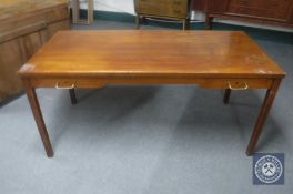 A mid 20th century teak writing table fitted two drawers