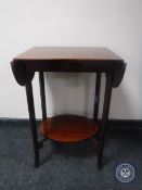 A mahogany two tier flap sided occasional table