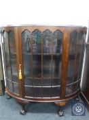An early 20th century mahogany D-shaped display cabinet on claw and ball feet