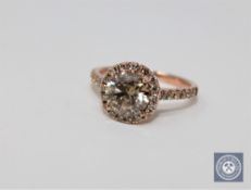 A 14ct rose gold diamond ring featuring center one round brilliant cut diamond 1.